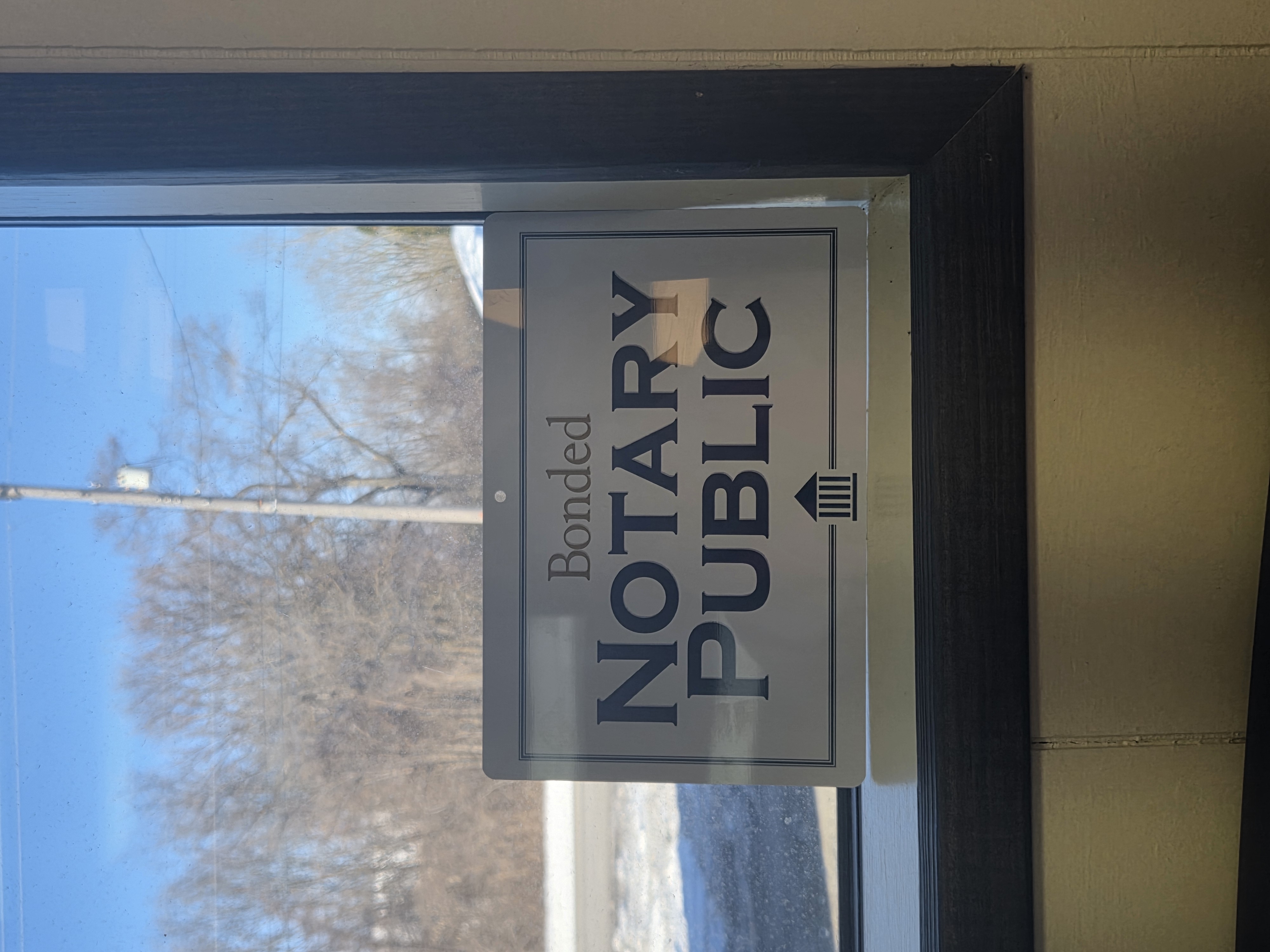 White sign that reads Bonded Notary Public